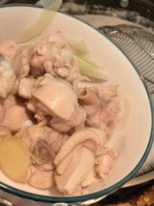 Blanched chicken pieces draining