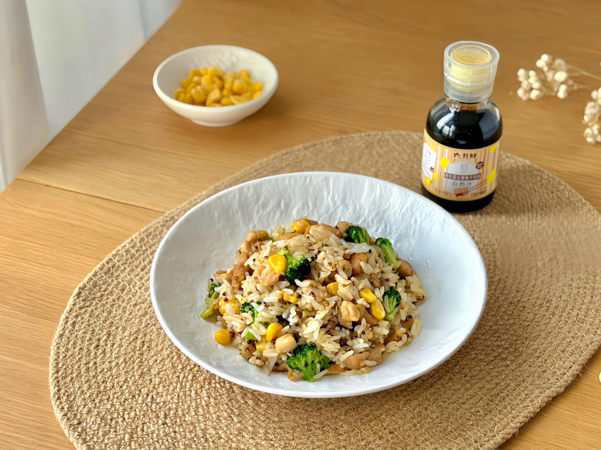 Chicken thigh multigrain rice bowl with quinoa rice, broccoli, and corn in a bowl