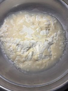 Put the flour and salt in a large bowl and stir to combine, pour in the freshly boiled water and stir quickly with chopsticks until it turns into shaggy flakes, then add the cold w