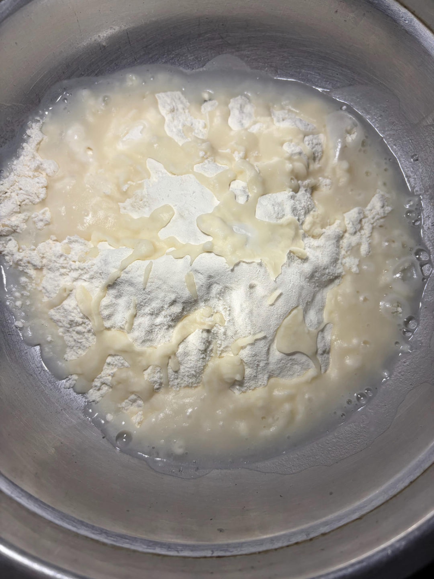 Put the flour and salt in a large bowl and stir to combine, pour in the freshly boiled water and stir quickly with chopsticks until it turns into shaggy flakes, then add the cold w