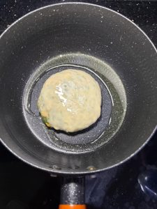 Preheat a frying pan with oil, add the pancake and cook over medium-low heat, flipping back and forth; fry one side until golden and set before flipping to the other side, and remo