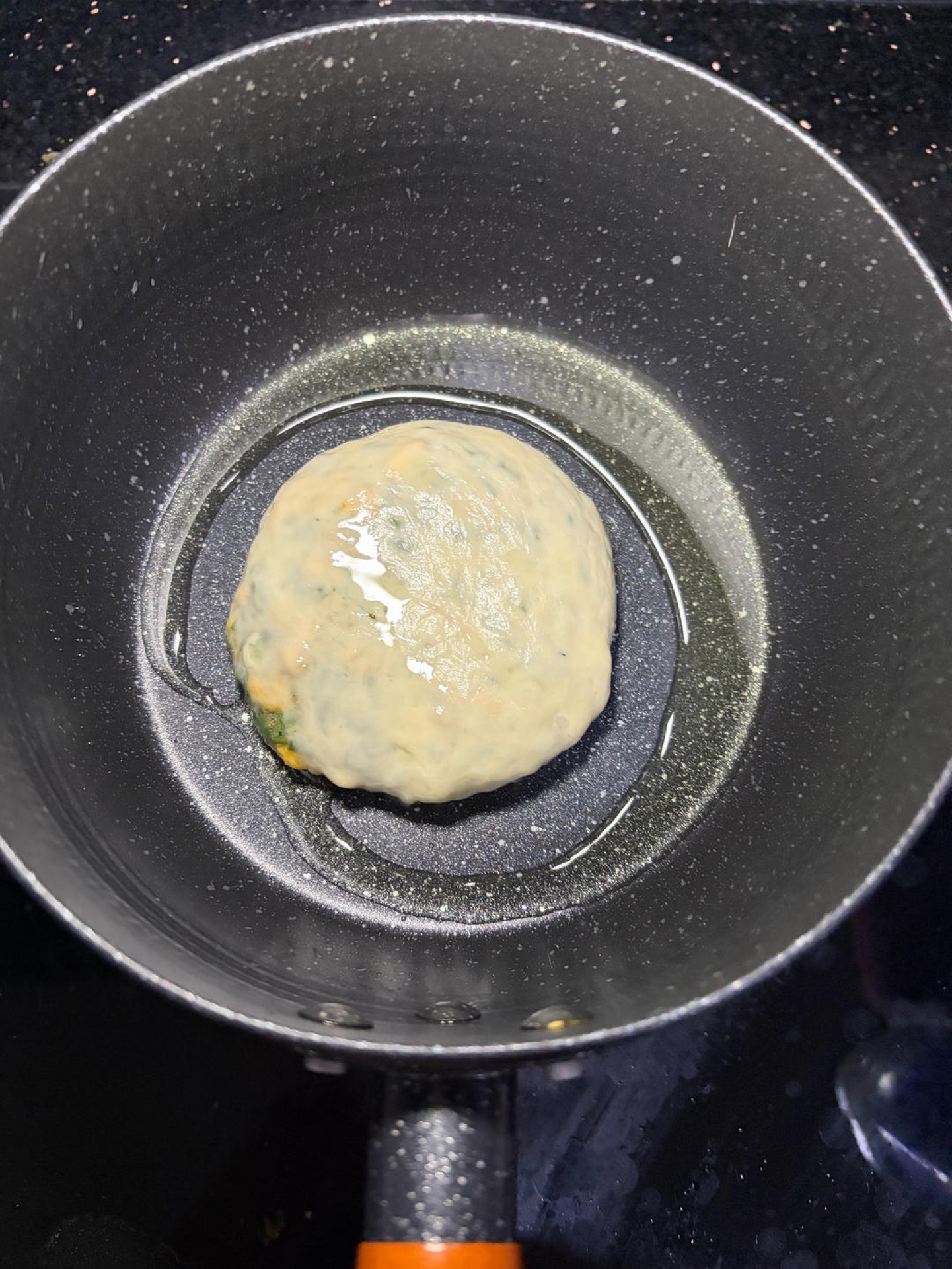Preheat a frying pan with oil, add the pancake and cook over medium-low heat, flipping back and forth; fry one side until golden and set before flipping to the other side, and remo