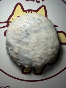 Place the sealed side down and gently press it into a thin pancake; do not roll it with force or the skin will tear and the filling will leak out.