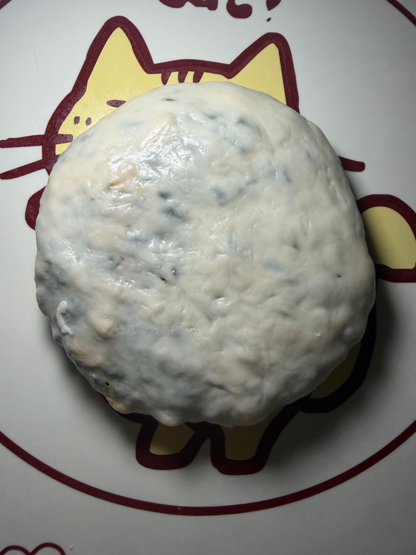 Place the sealed side down and gently press it into a thin pancake; do not roll it with force or the skin will tear and the filling will leak out.