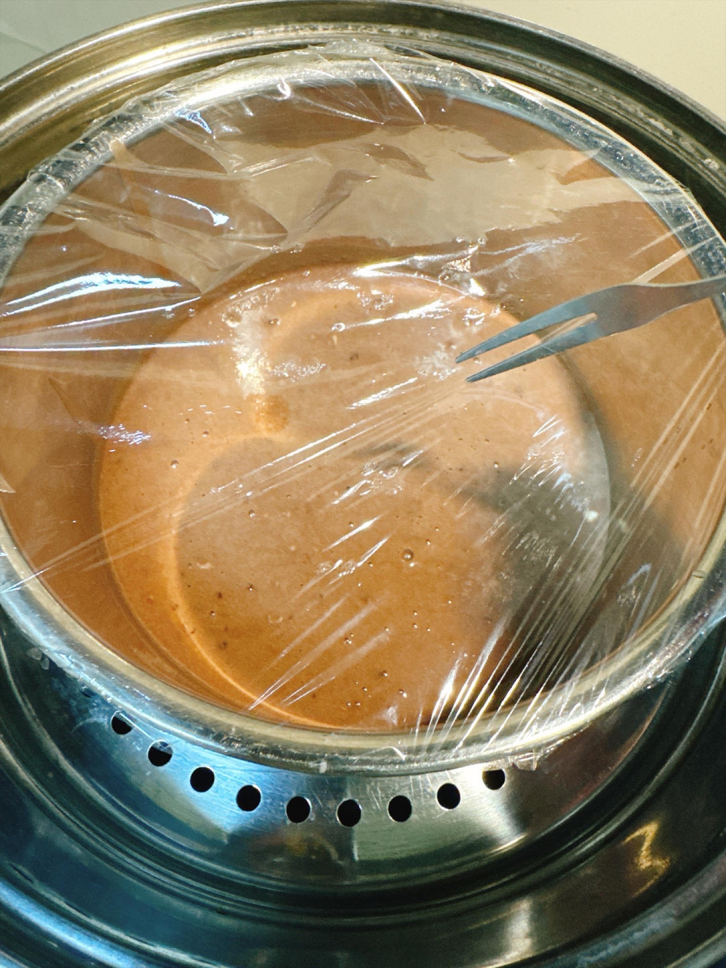 Covered bowl of mochi batter in the steamer