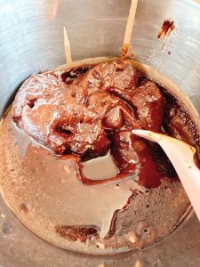 Oil being stirred into the steamed mochi dough