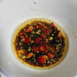 Stir soy sauce, vinegar, salt, and water into the bloomed aromatics.