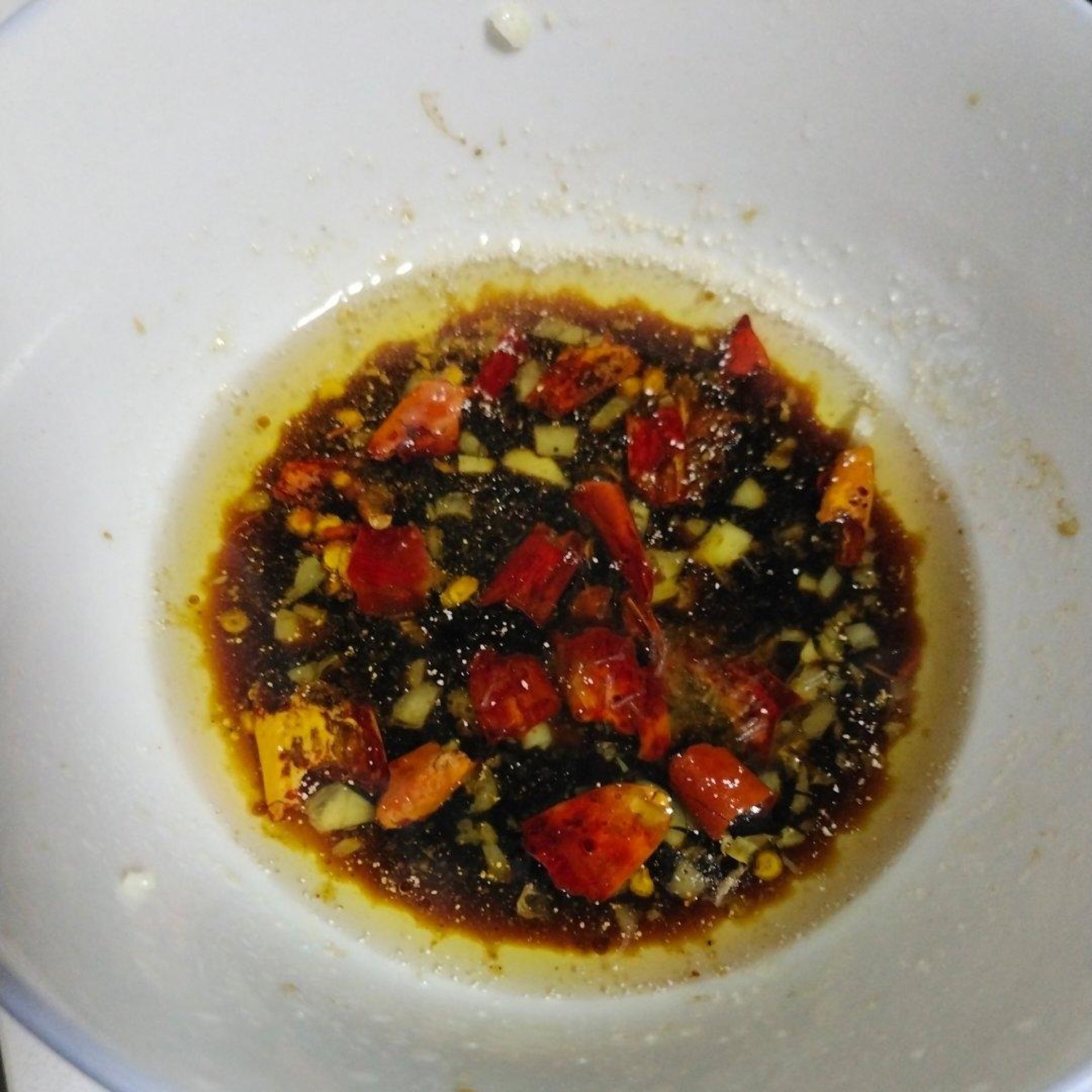 Stir soy sauce, vinegar, salt, and water into the bloomed aromatics.