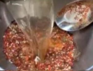 Hot oil poured over chili spices to make the sauce