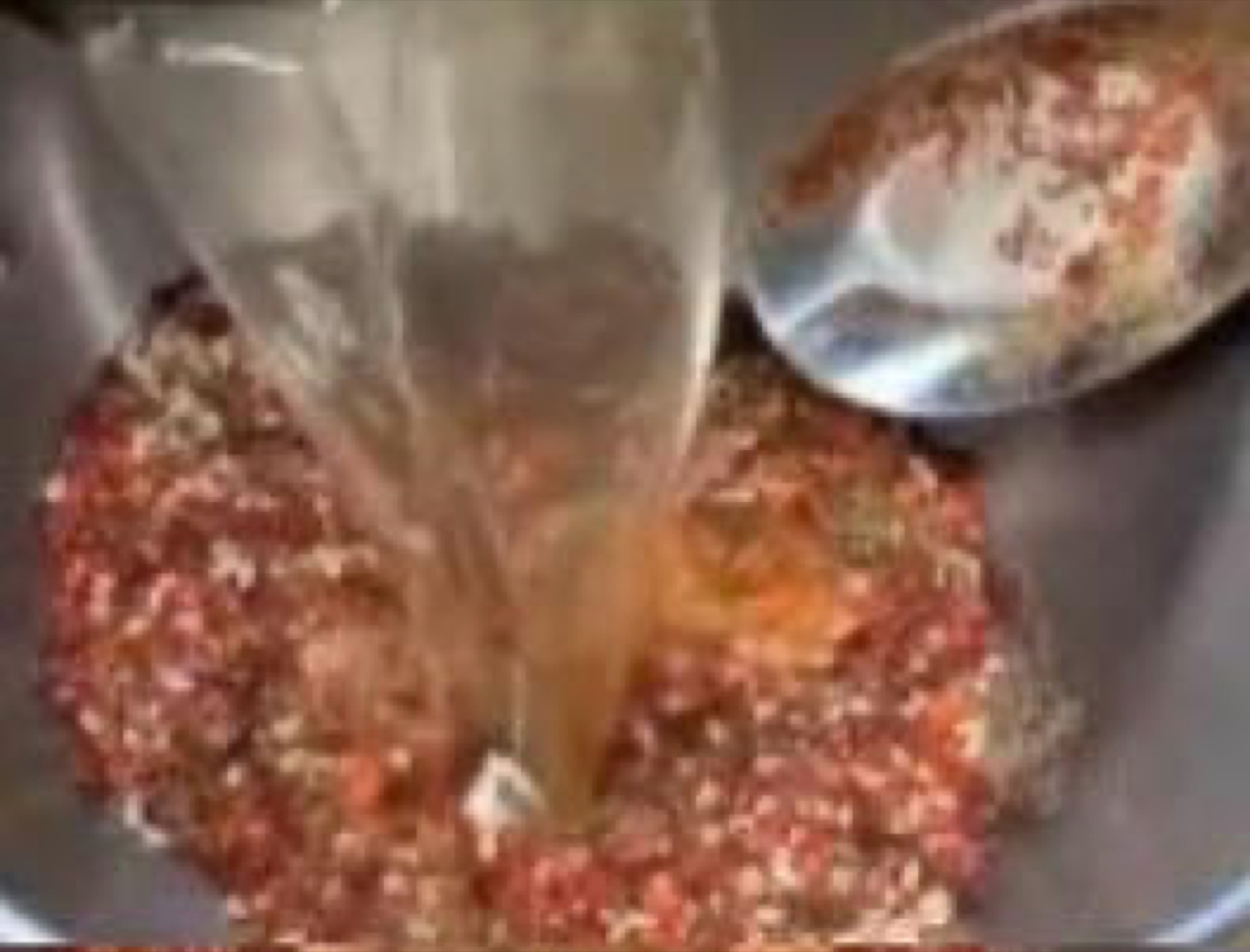Hot oil poured over chili spices to make the sauce