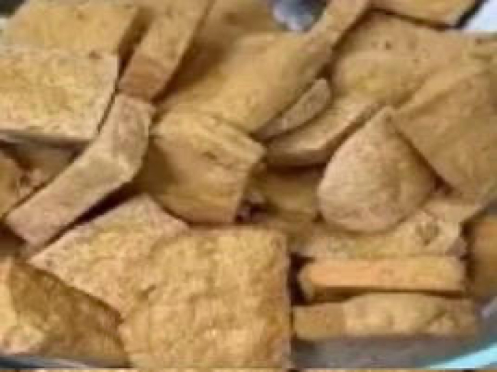 Fried tofu draining on a rack
