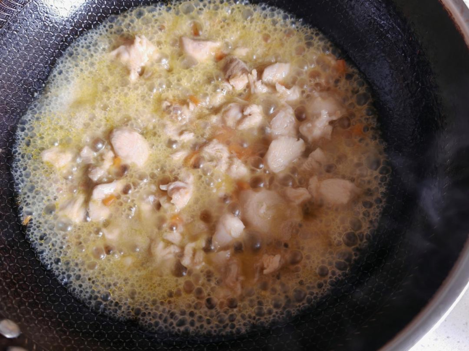 Add boiling water until it comes level with the chicken, then simmer over medium heat for 10 minutes.
