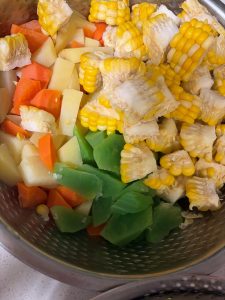 Carrot, celtuce, broccoli and bell pepper blanching briefly in a pot