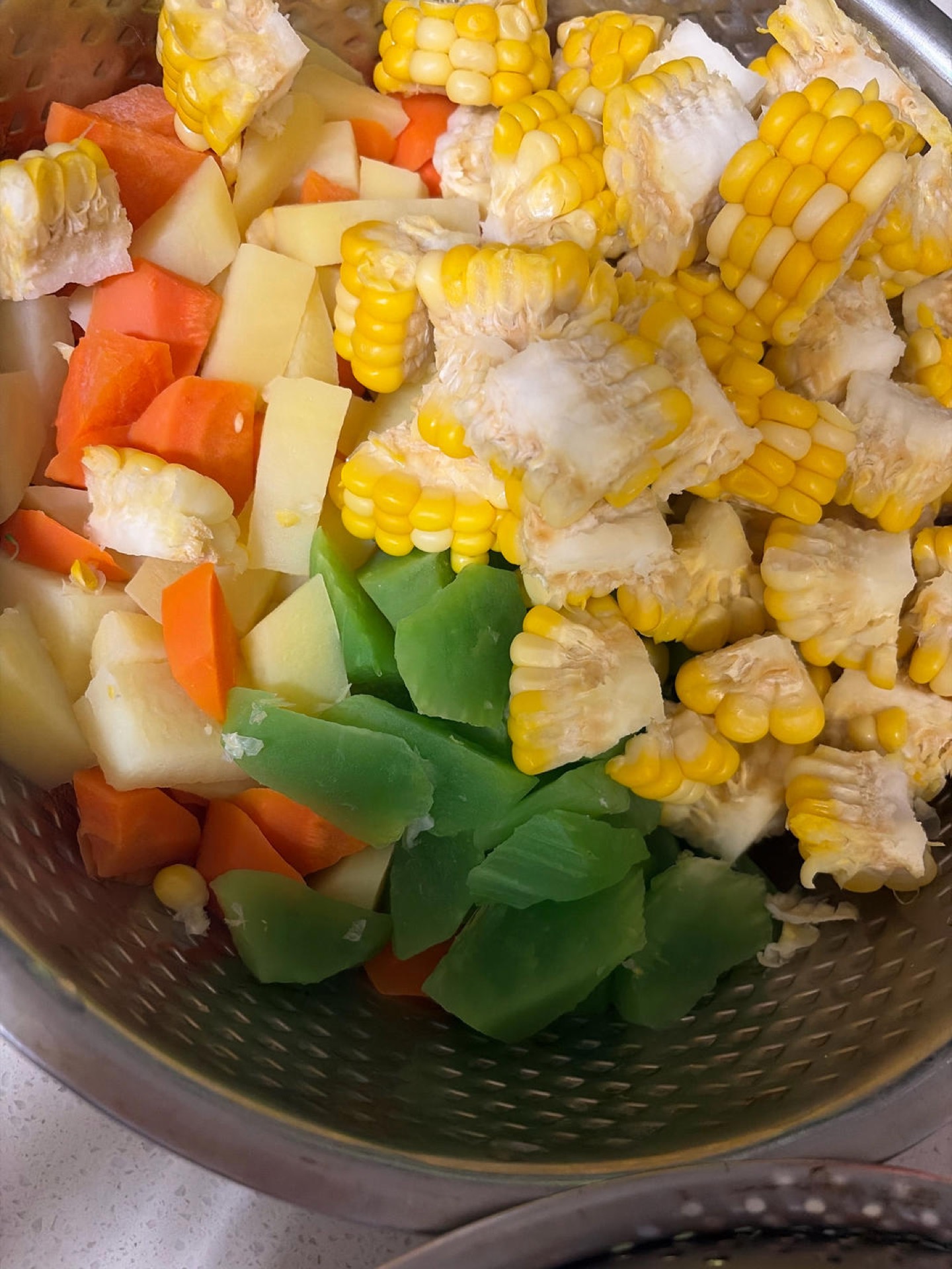 Carrot, celtuce, broccoli and bell pepper blanching briefly in a pot