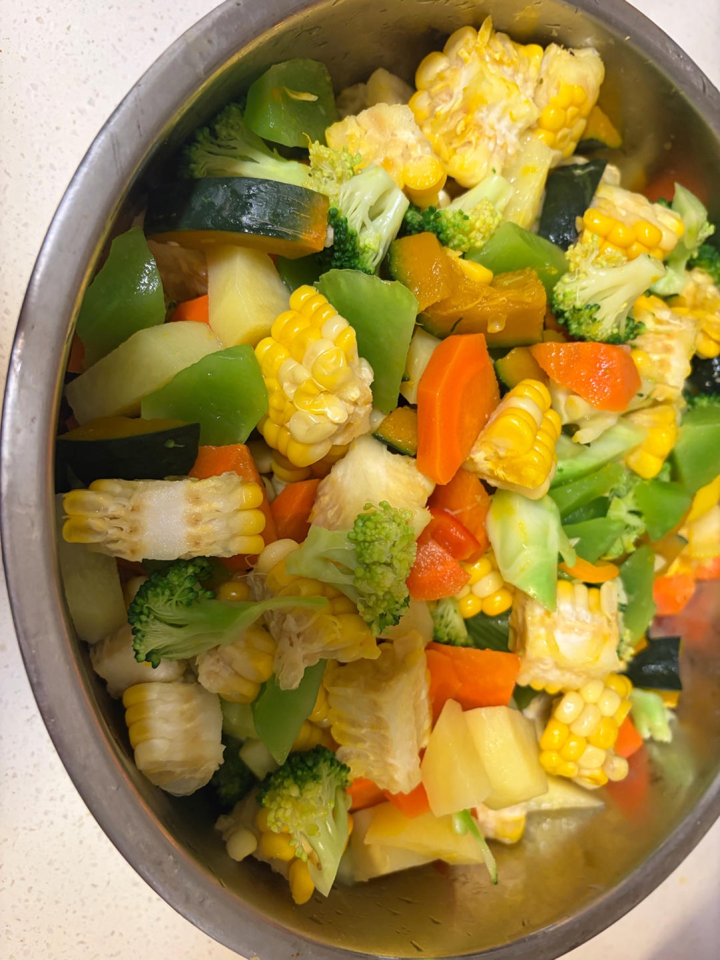Blanched vegetables combined together in a large bowl