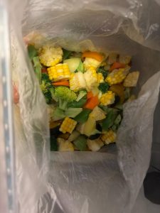 Blanched vegetables sealed in a large freezer bag ready for the freezer drawer
