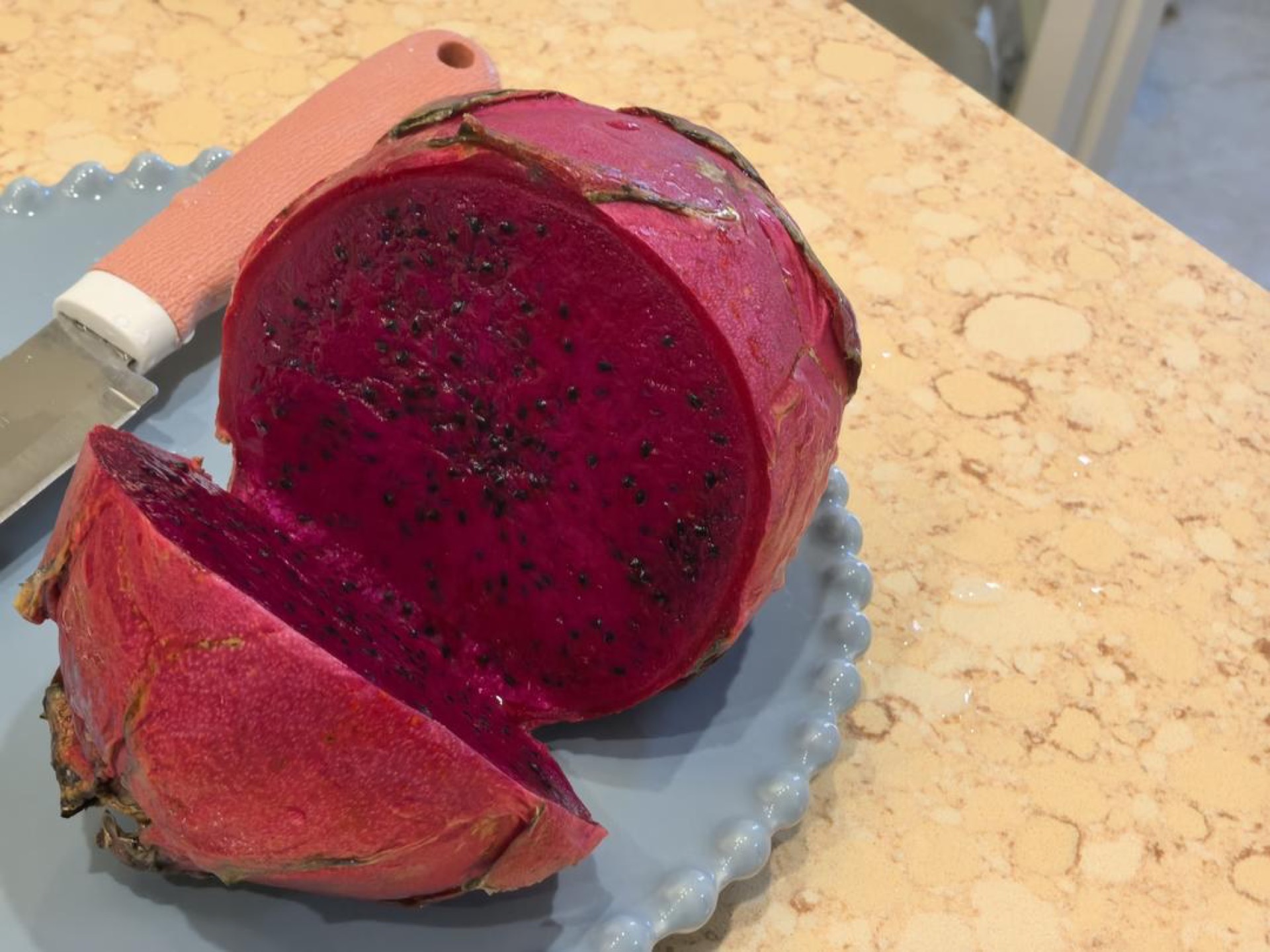 Pink dragon fruit cookies arranged on a plate