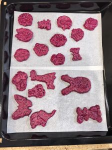 Cookie dough cut into squares with a mold