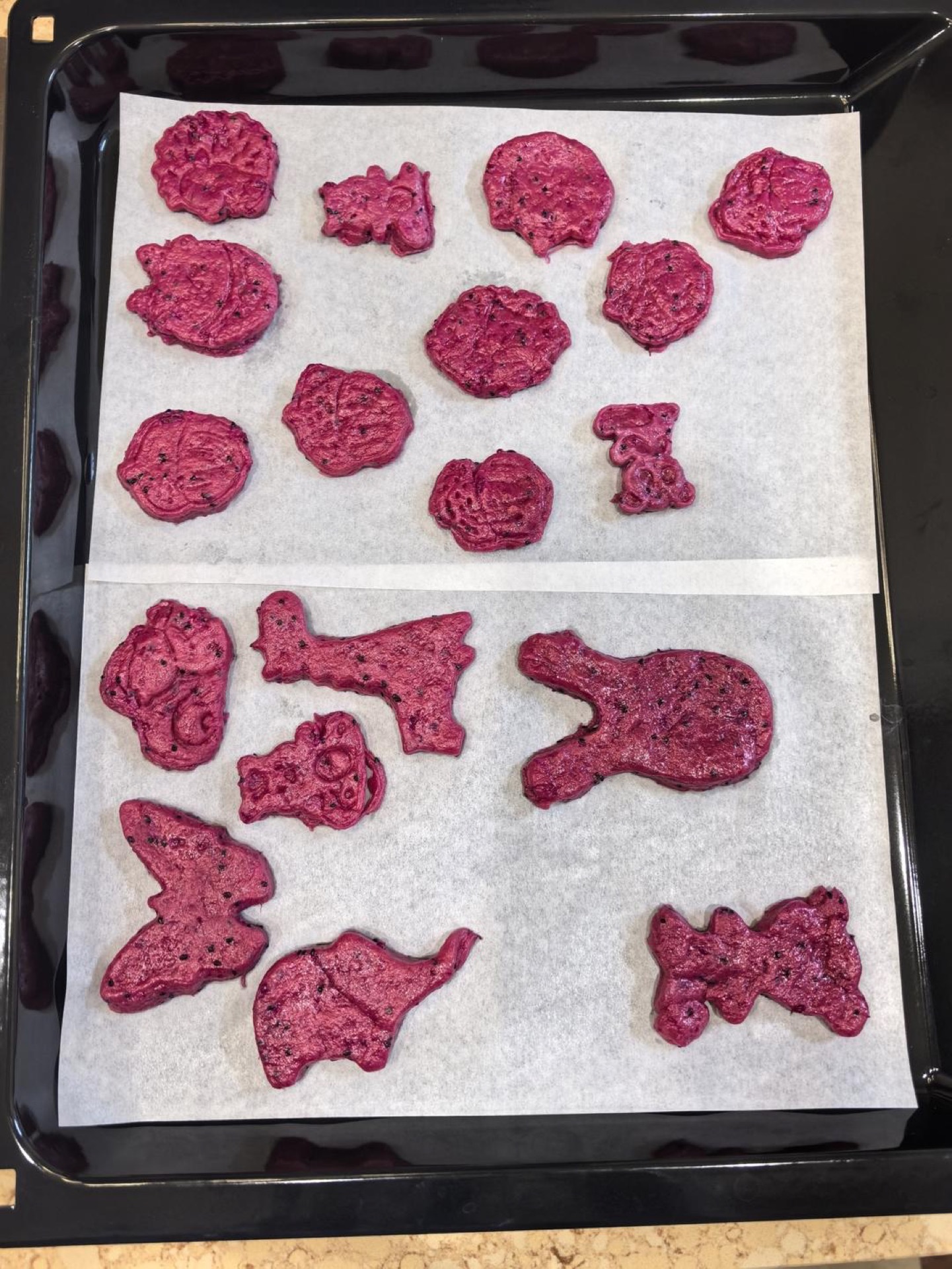 Cookie dough cut into squares with a mold