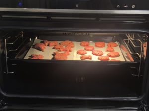 Tray of pink cookies going into the oven