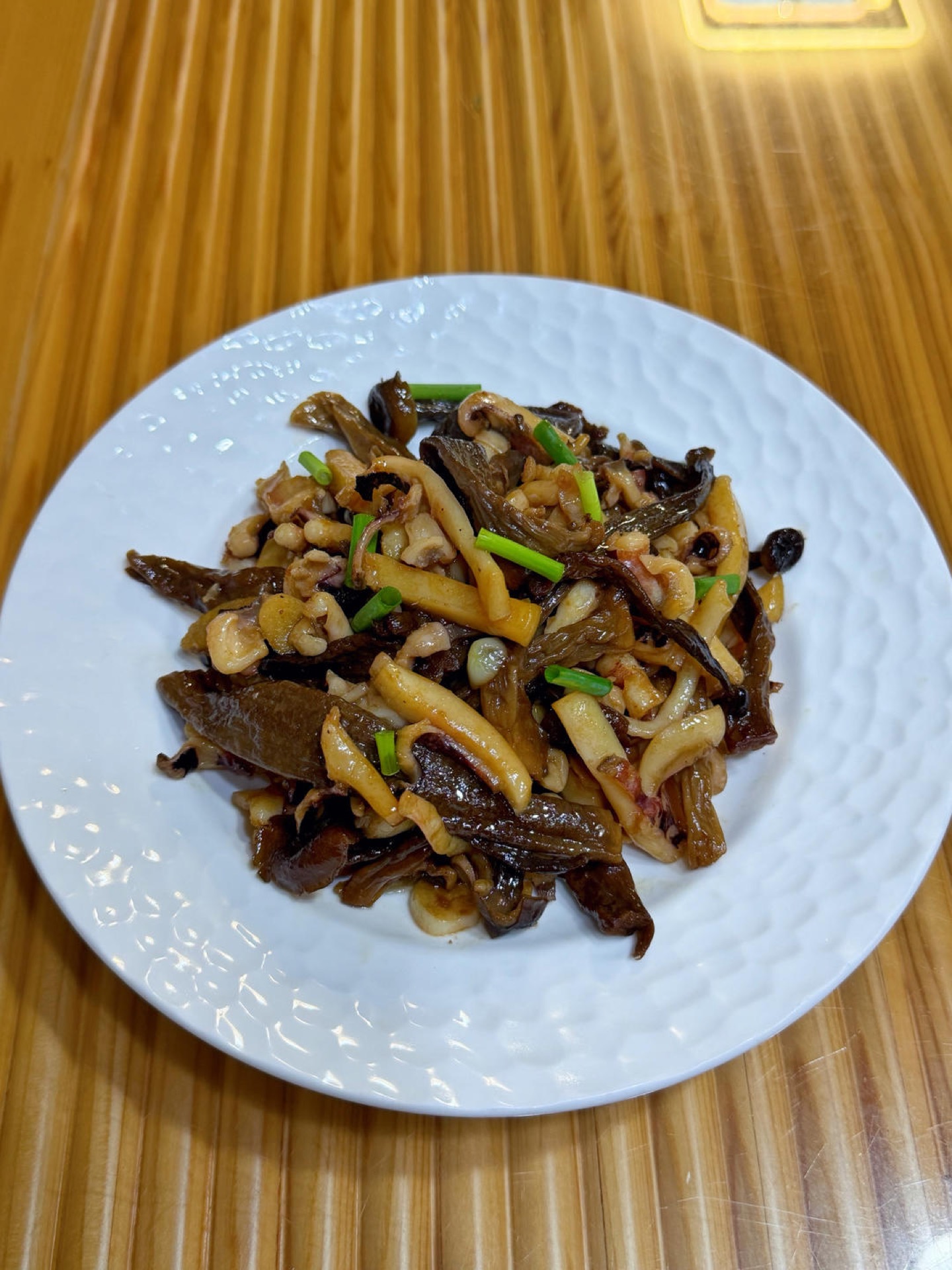Dried cuttlefish stir-fry with velvet shank mushrooms in a wok