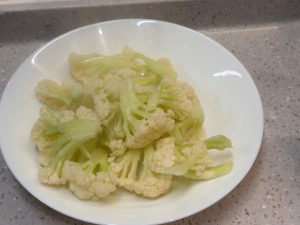 Wash the cauliflower and blanch it in boiling water.