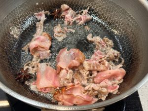 Add a little more oil to the wok, add the Sichuan peppercorns and star anise, and if you do not mind the extra step, add the scallions, ginger, and garlic too.