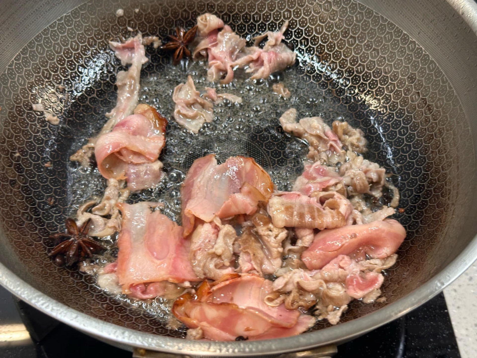 Add a little more oil to the wok, add the Sichuan peppercorns and star anise, and if you do not mind the extra step, add the scallions, ginger, and garlic too.