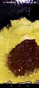 Add a generous pour of oil to the hot wok, add the sliced ginger and smashed garlic, stir until fragrant, then add the Sichuan chili bean paste and fry until the oil turns a deep r