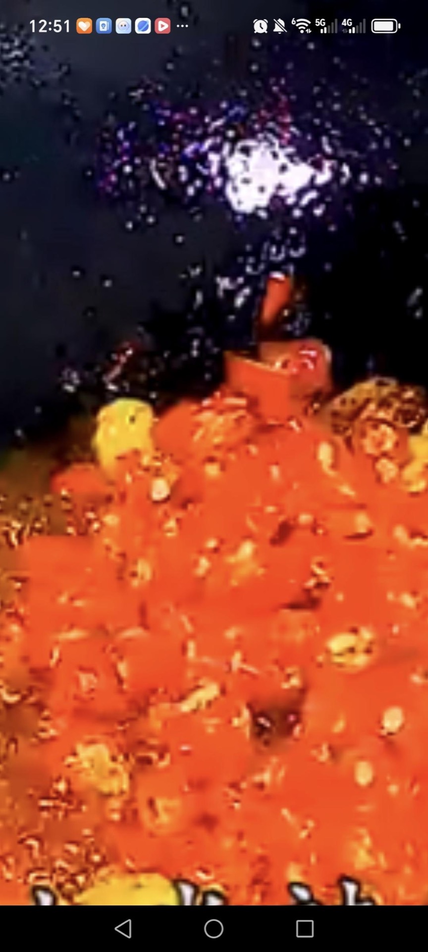 Toss the sliced fresh red chilies into the red oil and stir them briefly so they soften without losing their bright color.