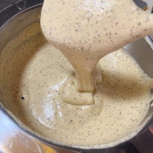 The batter falling in a thick ribbon from the whisk