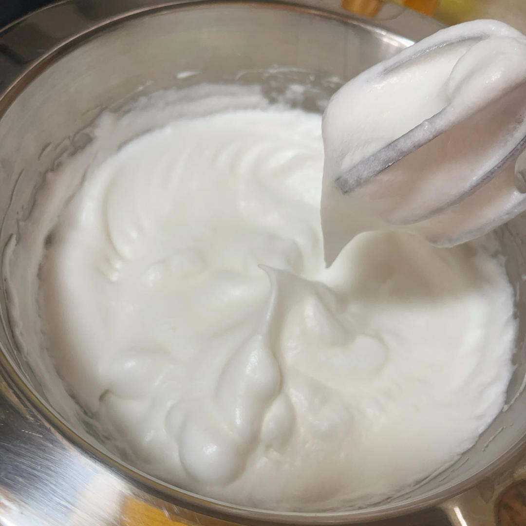 Meringue whipped to firm glossy peaks