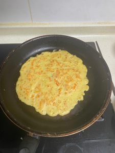 After about one minute the edges will lift and the surface will look dry and matte — slide a spatula under the pancake and flip it, then cook the second side for another 30 to 45 s