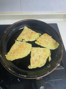 Slide the pancake onto a cutting board and cut it into small squares or strips that are easy for little hands to pick up, then repeat with the remaining batter — each pancake takes