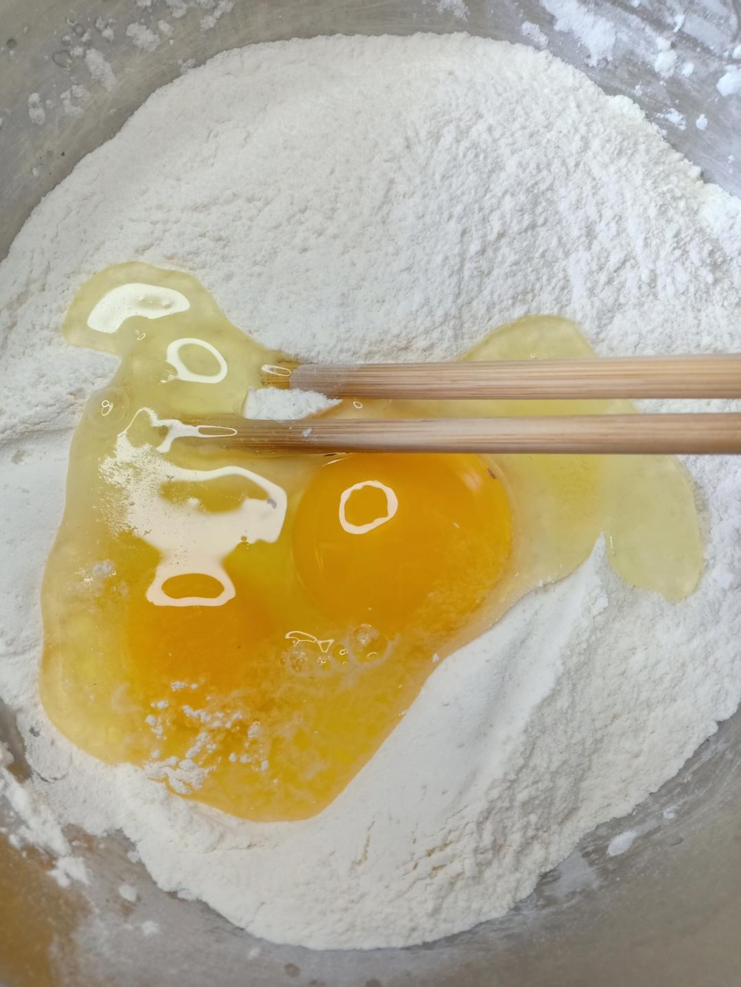 Whisk flour salt sugar and yeast in a bowl then add eggs and warm water