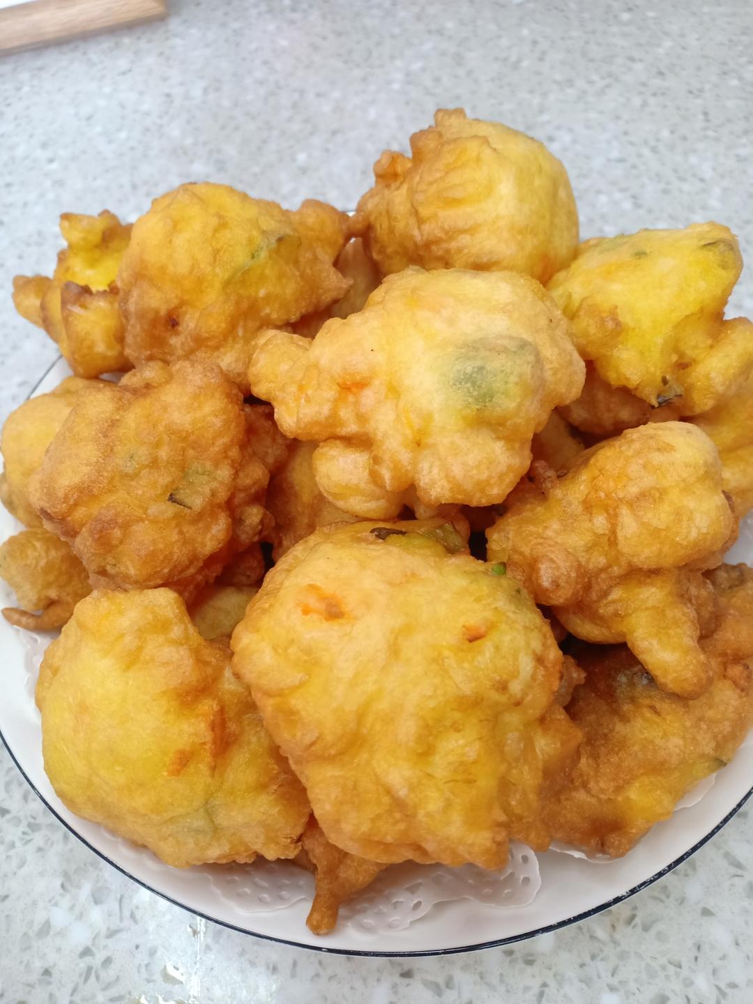 Drain the fried golden egg puffs on paper towels