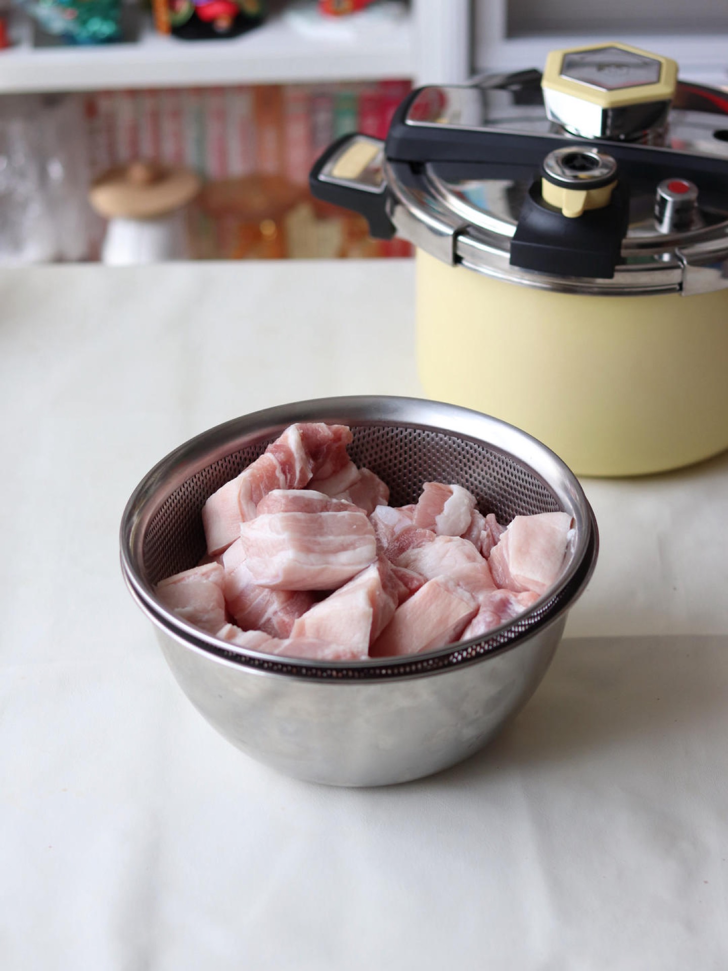 Cubes of skin-on pork belly on a cutting board