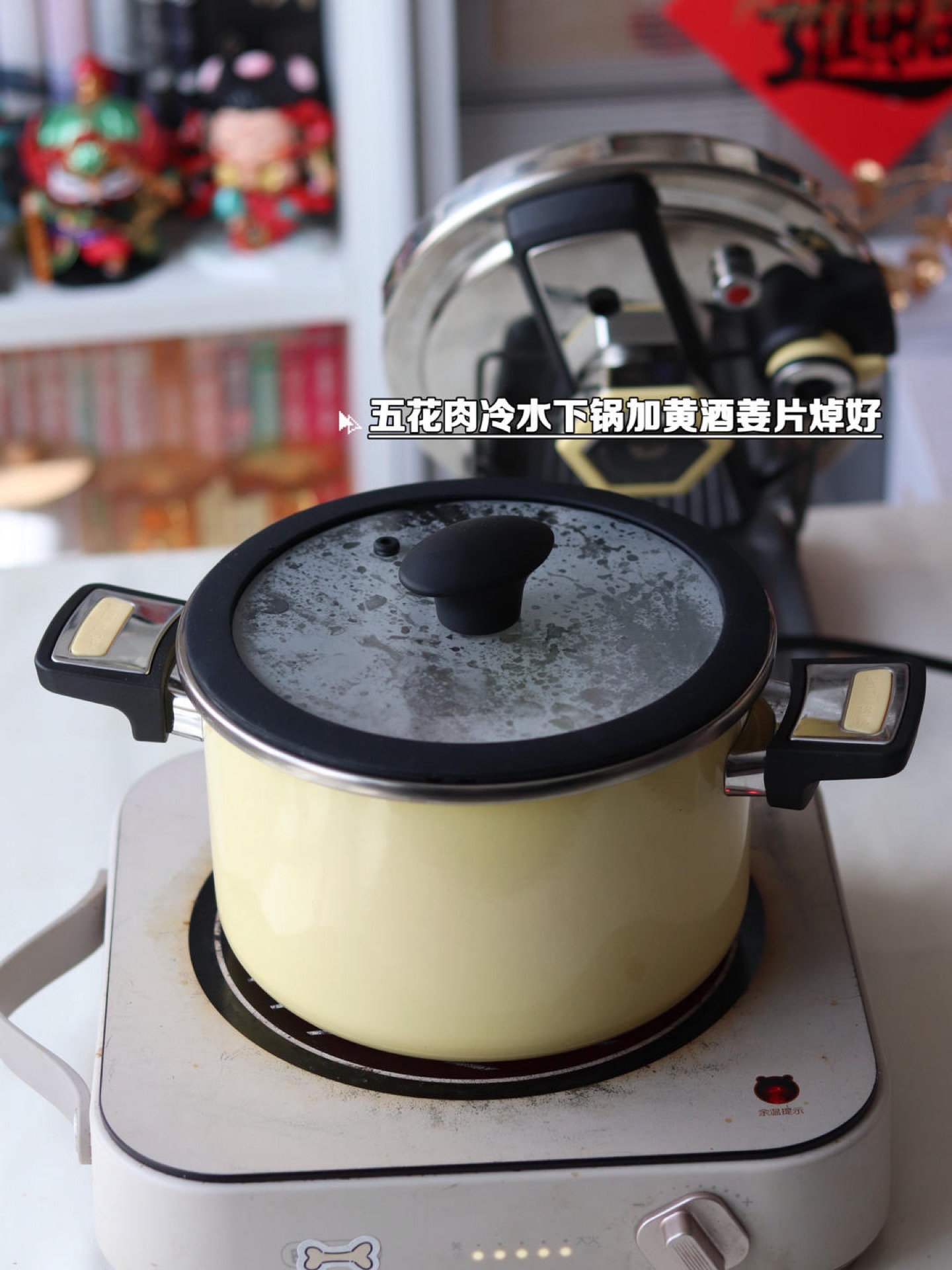 Blanched pork belly pieces being transferred into the pressure cooker