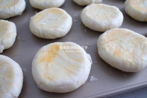 Flipping the mooncakes over on the baking sheet