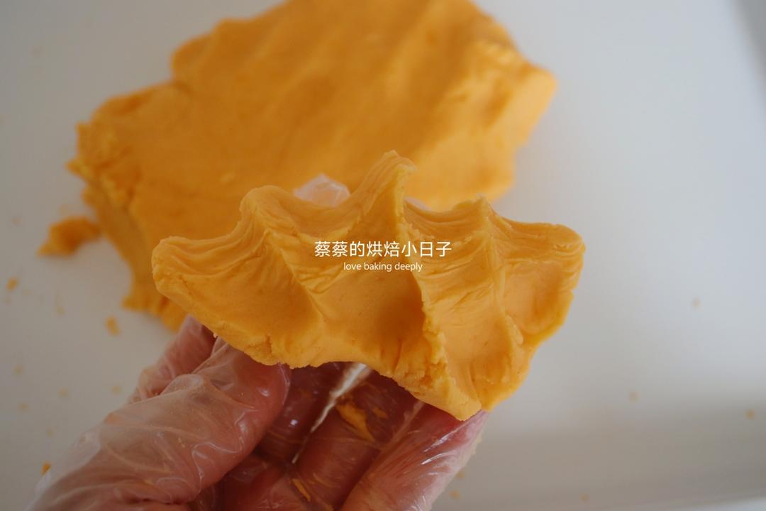 Mixing the crushed salted egg yolks into the white bean paste