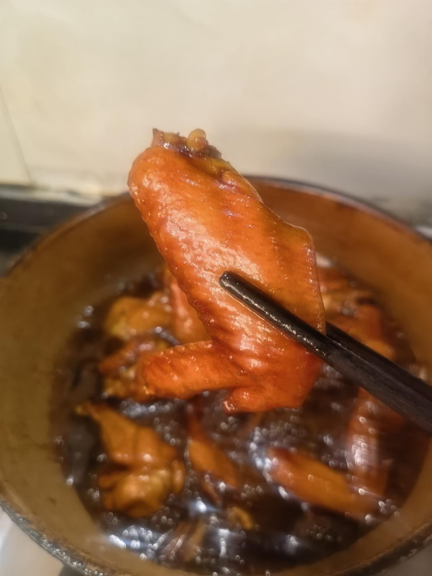 Glossy four-cup chicken wings in a dark caramel glaze