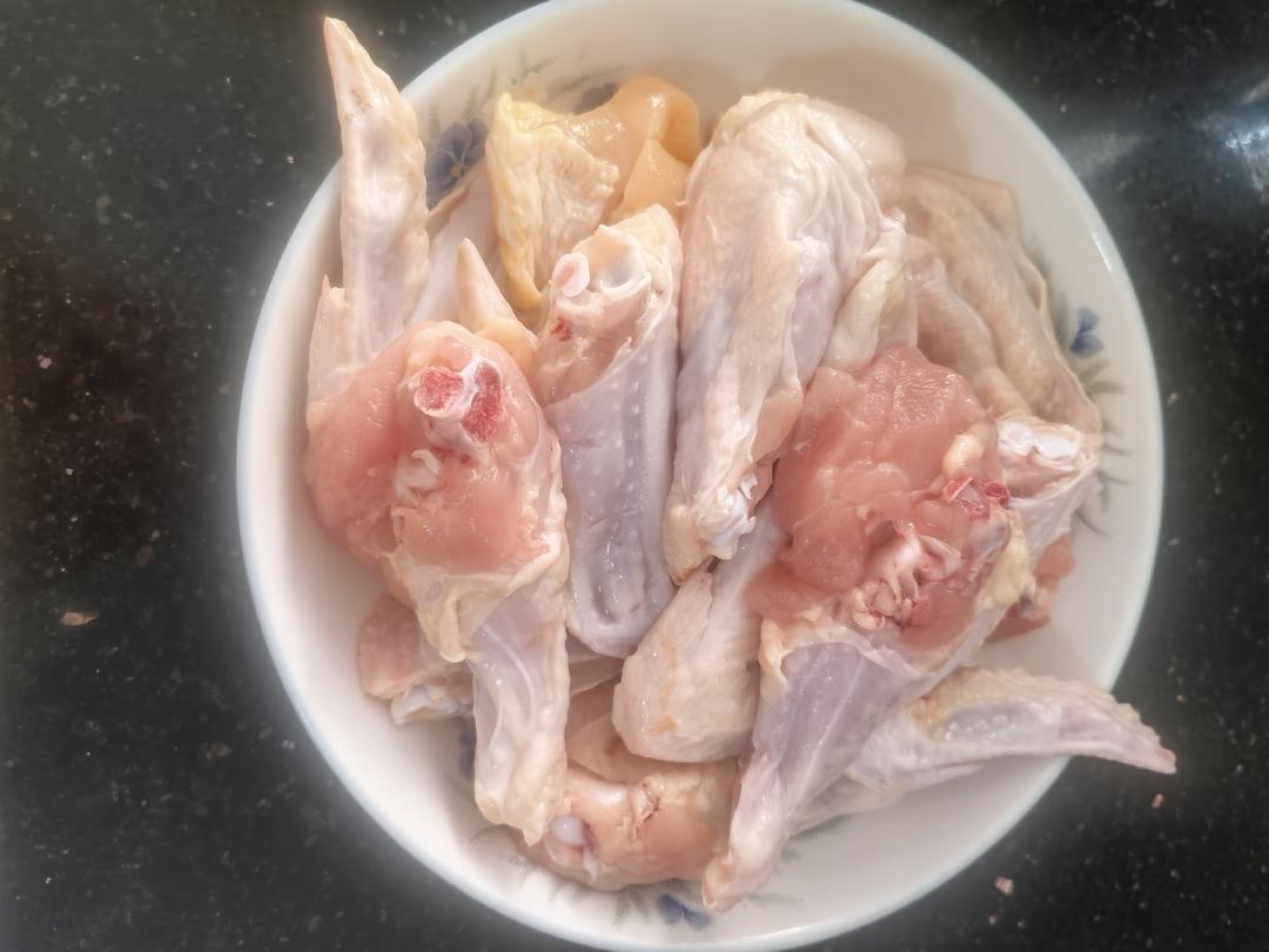 Chicken wings cut in half on a board