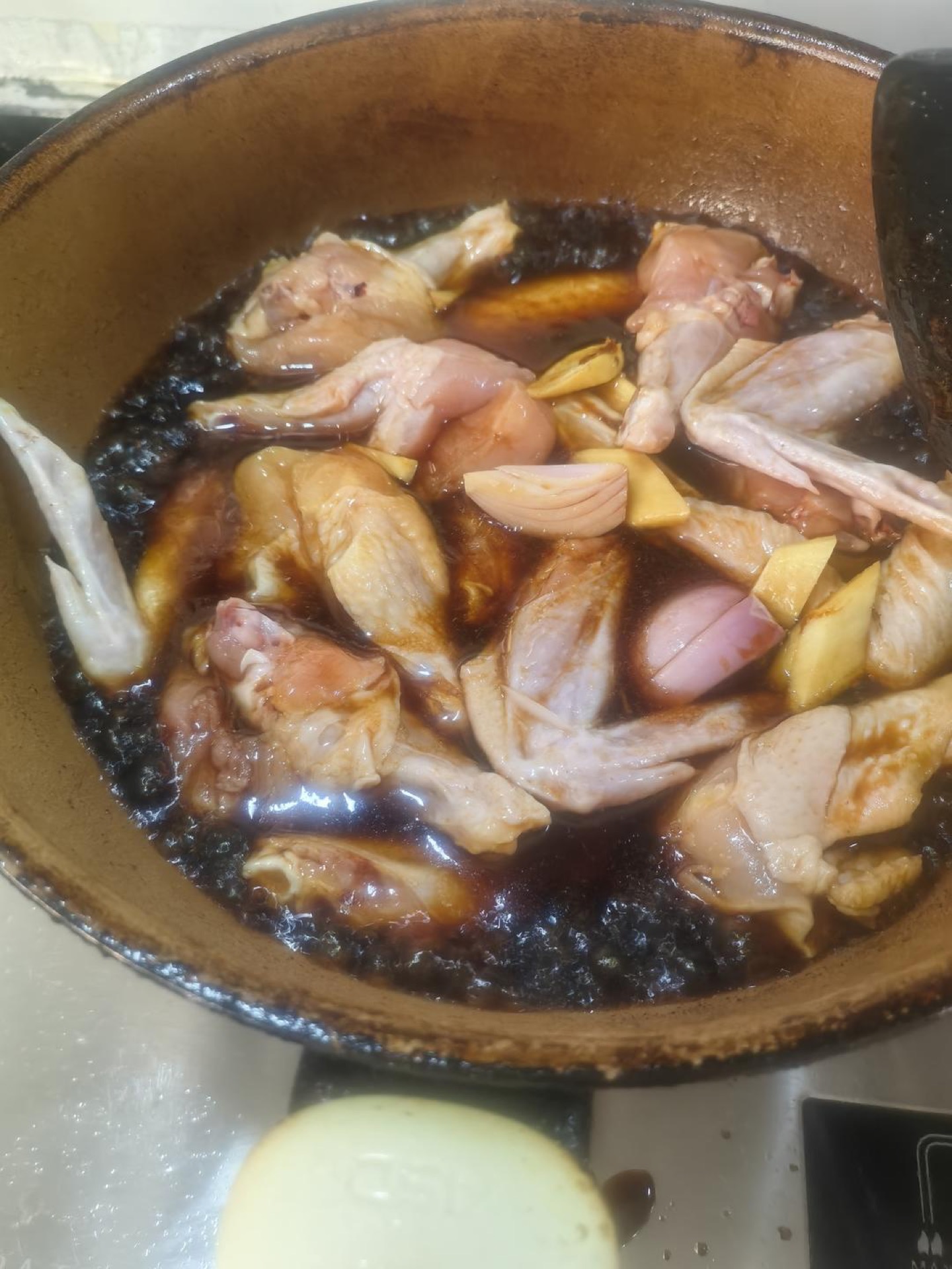 Chicken wings simmering in the soy and wine sauce