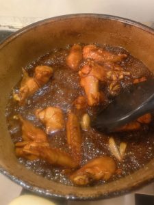 Chicken wings turned over in the pan