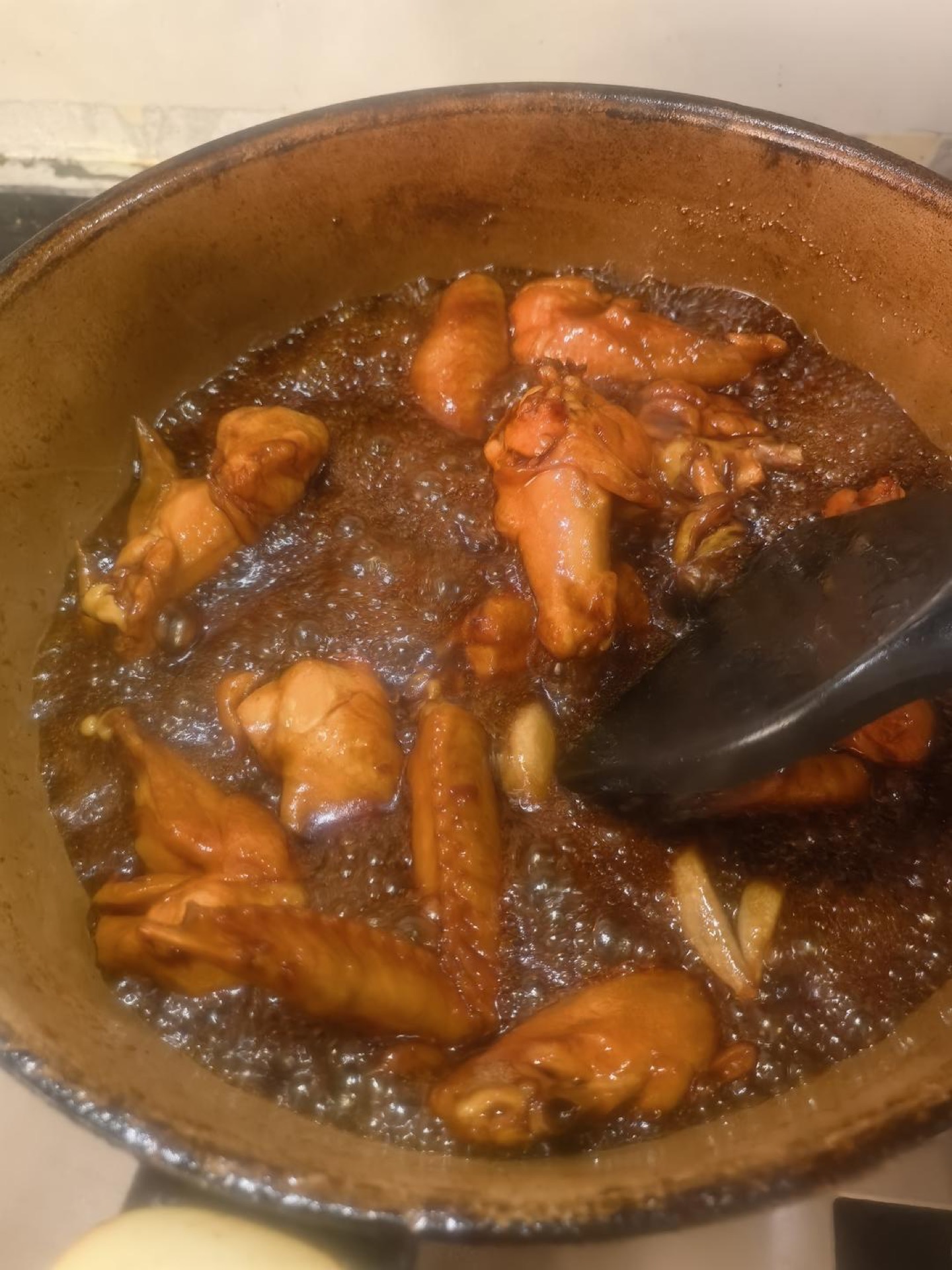 Chicken wings turned over in the pan