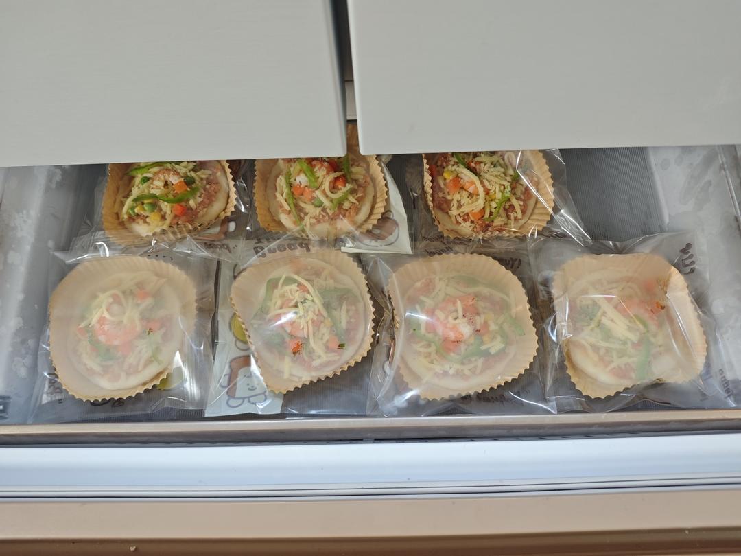 Frozen mini pizzas being finished in the air fryer
