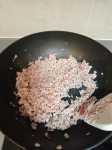 Ground pork browning with the onion and garlic