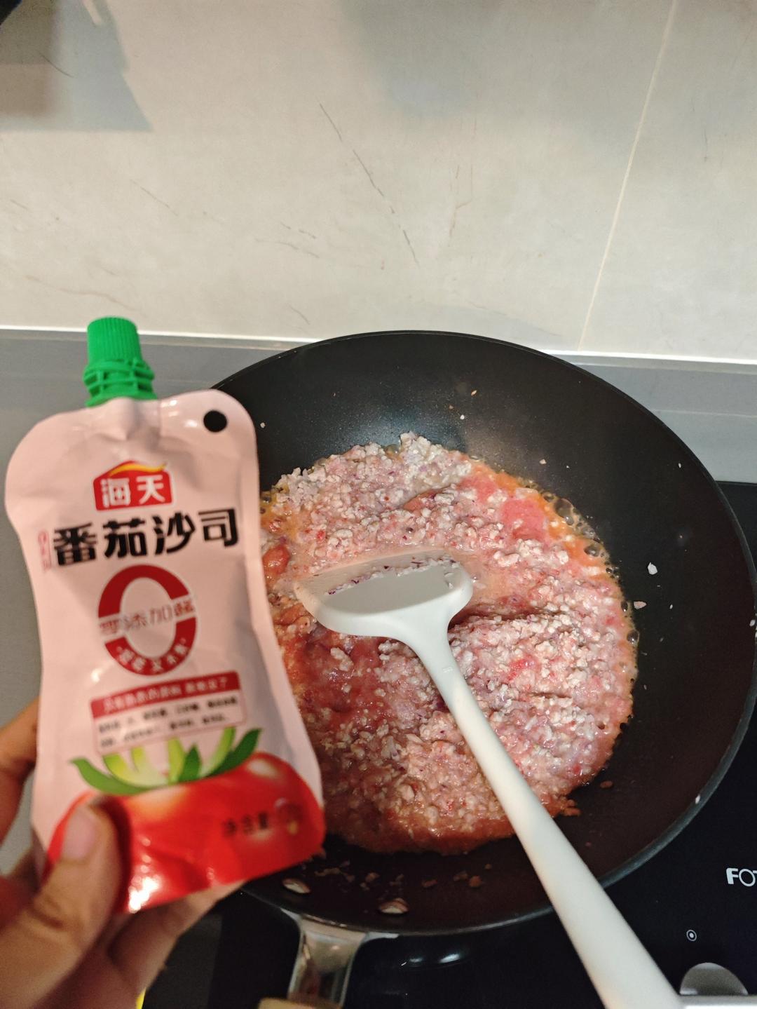 Tomato purée and tomato paste added to the pork sauce