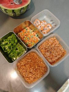 Assorted pizza toppings ready in small bowls