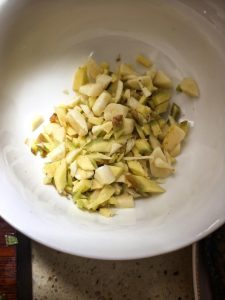 Sliced ginger and garlic on a small plate